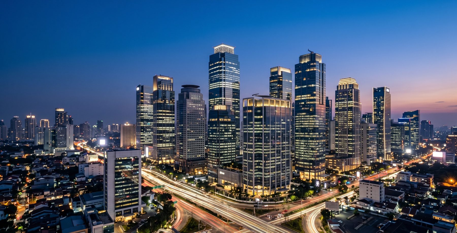 Jakarta city skyline at night with light trails — the dynamic home market of Majapahit Group, connecting Indonesia with global capital markets